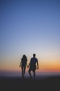 couple-holding-hands-at-sunset