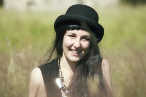 girl-in-field-with-black-hat